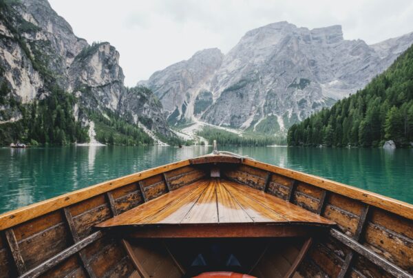 Small boat on lake surrounded by mountains