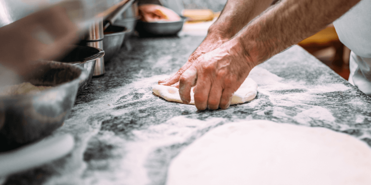 Photo of hands rolling dough out