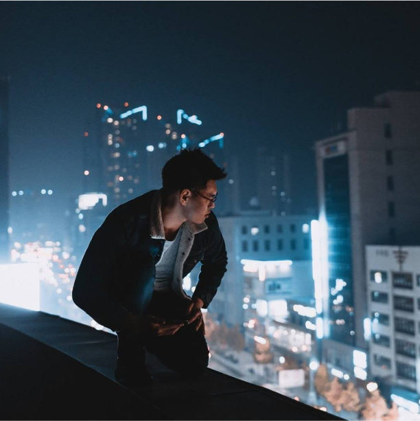 Man viewing streets from top of building
