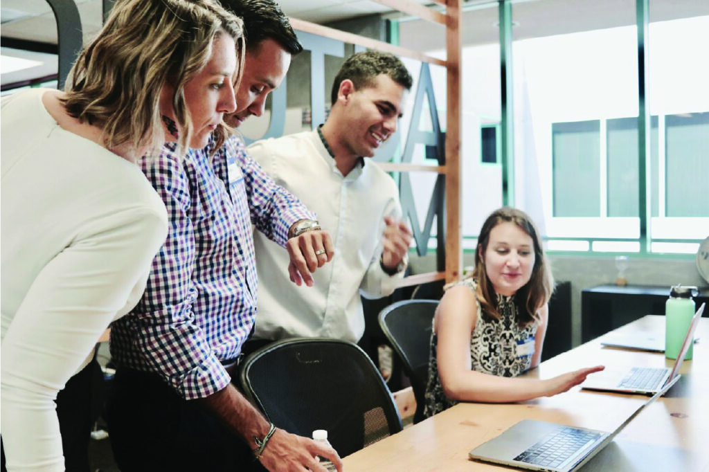 Coworkers collaborating in front of desk